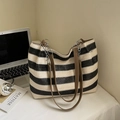 Large woven tote bag with black and white stripes and brown leather straps - Black
