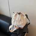 Off-white nylon drawstring bucket bag with cat embroidery and adjustable strap - Off-white