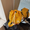 Bright yellow nylon bucket bag with a cute cat logo and an adjustable black strap - Yellow