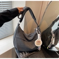 Detail of grey canvas dumpling bag with adjustable strap and cute Capybara charm - Black with Pendant
