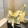 Cream yellow hobo shoulder bag featuring large bow detail and silver studs with wide strap - Yellow