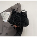 Minimalist black matte leather handbag with bow drawstring and silver metal rings - One Size / Black