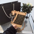 Brown bucket bag with monogram pattern and leather trim including a bear charm - Coffee And Apricot