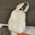 Minimalist cream white nylon backpack with front zipper pocket and functional side compartments - White
