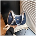 Detailed shot of a blue denim crossbody bag with golden butterflies and silver straps - Royal Blue