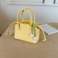 Bright yellow bucket bag with JonJon embossing and white tulip charm detail - Yellow