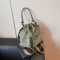 Versatile bean green nylon drawstring bucket bag with adjustable straps and front pocket - Green