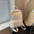 Creamy white backpack featuring heart-shaped quilting and wide woven shoulder straps - Off-white