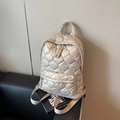 Champagne gold quilted backpack with a diamond stitch pattern and glossy finish - Gold