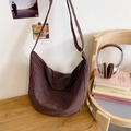 Brown checkered large canvas hobo bag with adjustable strap in casual lifestyle setting - Brown