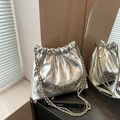 Chic silver metallic quilted bucket bag with chain strap and gold logo detail - Silver