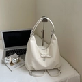 White minimalist multi-purpose backpack with bow detail and heart pendant on a desk - Off-white Without Pendant