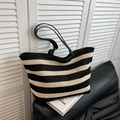 Black and white striped knitted tote bag with leather straps in a minimalist chic style - Black
