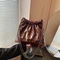 Dark brown quilted bucket bag with chain strap and metallic Clear K heart charm details - Brown