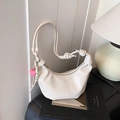 Bolso hobo blanco con correa anudada y colgante de corazón rosa en escena interior - Estilo Con Colgante / Blanco