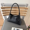 Minimalist black woven leather hobo bag with braided handle and round pendant charm - Black
