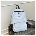 Close-up of light gray nylon travel backpack with textured fabric and red brand tag - Blue