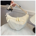 Detail of cream crescent canvas bag featuring woven rope zipper and adjustable wide strap - Standard / Off-white