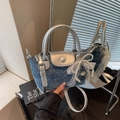 Blue denim mini square bag with pearl bow and silver circular handles in mirror view - Dark Blue With Pendant