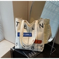 Dettaglio della borsa tote in tela con stampa TEN 1985 e toppe colorate su specchio - Bianco Sporco