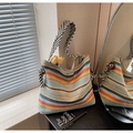 Detail of colorful striped woven beach bag with wide herringbone strap and tulip decor - Colorful