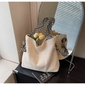 Detail of cream woven straw tote bag with black and white textured fabric handles - Off White