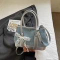 Light blue denim bucket bag with silver trim, lace bow, and pearl charm detail - Light Blue With Pendant