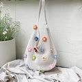 White hand-woven knit tote bag with multi-colored 3D crochet flowers and wide strap - Off-white