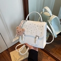 White faux leather backpack with rhinestones and plush bear charm for casual fashion - Off-white