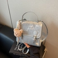 Silver metallic crossbody bag with sparkling rhinestones and a cute brown plush bear charm - Silver