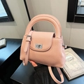 Pink quilted crossbody bag with top handle and metal twist lock closure - Pink