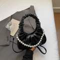 Fashionable black pleated cloud bag with glossy finish and pearl chain accessory - Black