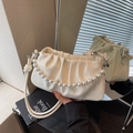 Elegant cream pleated cloud bag with pearl handle and stylish knotted shoulder strap - White