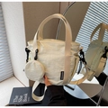 Detail of beige nylon tote bag with small coin purse and KAKADAISHU woven label - Off-white