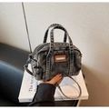 Close-up of black washed denim mini bowling bag with leather detail and adjustable strap - Dark Brown