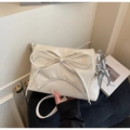 Detail of cream white pleated leather bag with large bow and silver balloon dog charm - Off-white