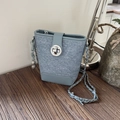 Light blue denim bucket bag with silver chain strap and peanut-shaped charm accent - Blue