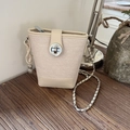 Beige bucket bag with canvas texture, chain strap, and creative peanut pendant - Off White