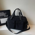Black large capacity nylon travel bag with multi-pocket design and adjustable shoulder strap - Black