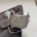 Gray pleated leather bucket bag with heart pendant and adjustable shoulder strap - Silver