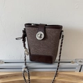 Brown bucket crossbody bag in textured canvas with chain strap and metallic charms - Brown