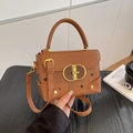 Brown faux leather crossbody bag featuring cartoon bear patterns and gold clasp hardware - Tan