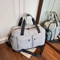 Light gray large travel bag with dual front pockets and adjustable shoulder strap - Gray
