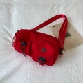 Minimalist red crossbody bag with multi-pocket nylon design and adjustable black strap - Red