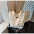 Detail of embroidered dachshund patterns and leather logo on white canvas tote bag - Off-white