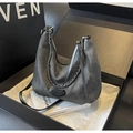 Detail view of washed denim hobo bag with chain strap on silk gift box setting - Dark Brown
