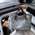 Light blue washed fabric tote bag with brown leather handles and fashion lettering - Blue