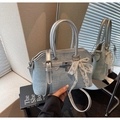 Close-up of light blue denim handbag with lace pearl bow and silver padlock detail - Light Blue With Pendant