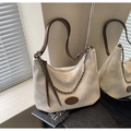 Detailed macro of beige canvas shoulder bag with brown leather trim and metal chain - Off White