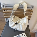 Off-white pleated crossbody dumpling bag with silver hardware and black drawstring detail - White